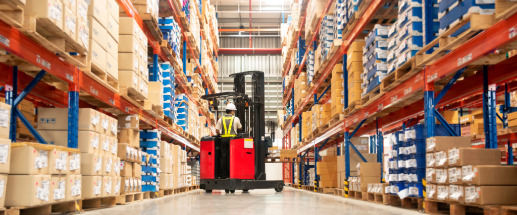 Warehouse aisle with forklift and driver.